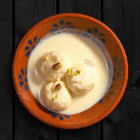 Rasmalai · Soft, small, and spongy flattened balls made by milk dunked in flavored sweet milk and pista...