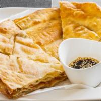Scallion Pancake (7 Pieces) · Pan-fried glutinous rice flour stuffed with scallion. served with ginger sauce.