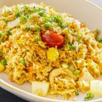 Pineapple Fried Rice · Fried Rice with egg, onions, pineapple, peas, scallions, and a touch of curry powder.