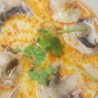 Tom Kha Soup · Mild chicken coconut soup seasoned with Thai spices, mushrooms, lime juice and scallion.