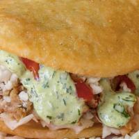 De Calle · Fried arepa with roasted pork, cabbage, and white cheese topped with ketchup and green mayo.