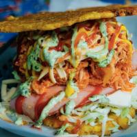 Patacón Pisao · Crispy fried green plantain sandwich with shredded chicken/shredded beef/or pork, ham, white...