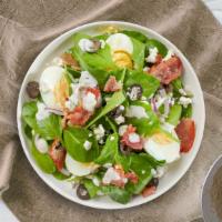 Spinach Salad · Spinach, feta, bacon, onion, olives, and two hard-boiled eggs tossed with house dressing.