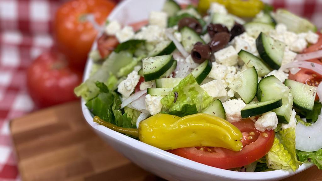 Greek Salad · A crisp bed of lettuce with feta cheese, sliced red ripe tomatoes, onions, cucumbers, olives & pepperoncini with your choice of dressing.