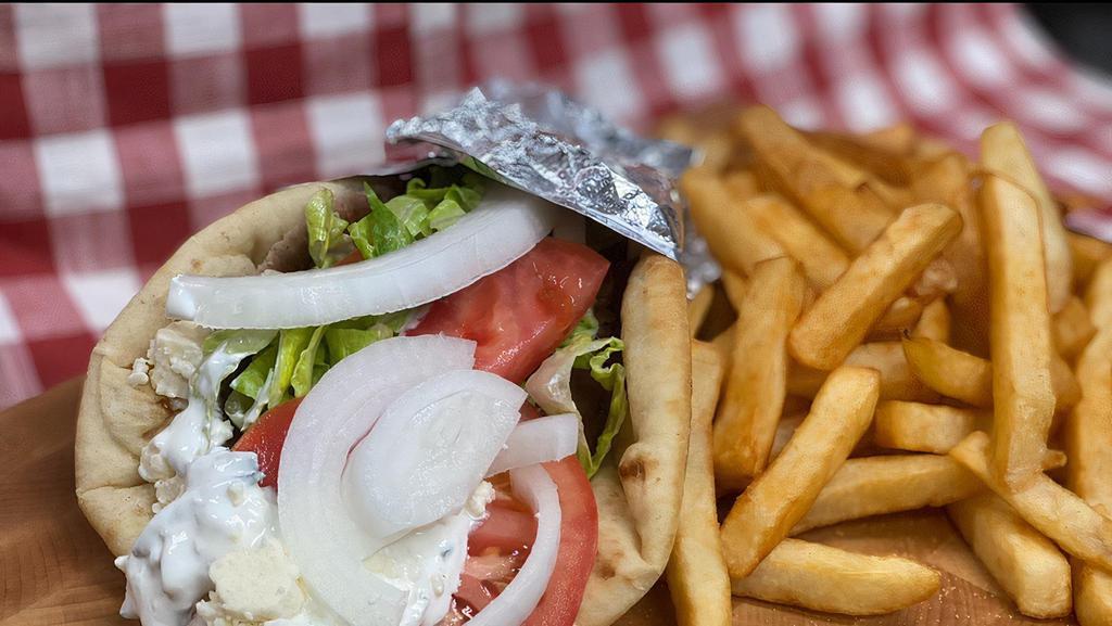 Chicken Yeros Platter · Seasoned grilled chicken breast with tomatoes, onions, feta, tzatziki sauce and fries wrapped in a lightly toasted pita bread with a side of fries.