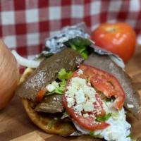 Yeros Sandwich · Strips of grilled lamb and beef with tomatoes, onion, feta, tzatziki sauce and fries wrapped...