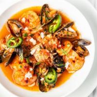 Sopa De Mariscos · Seafood tomato broth with mussels, clams, shrimp, shredded crab meat and white fish.