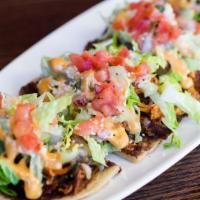 Chicken Huarache · Handmade corn flat bread topped with refritos black beans, grilled chicken mixed with bacon,...