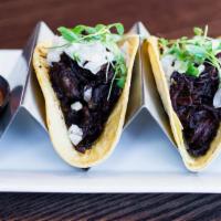 Beef Barbacoa Tacos · Shredded beef, slow-cooked in its own juice with spices and peppers, raw onion and cilantro
