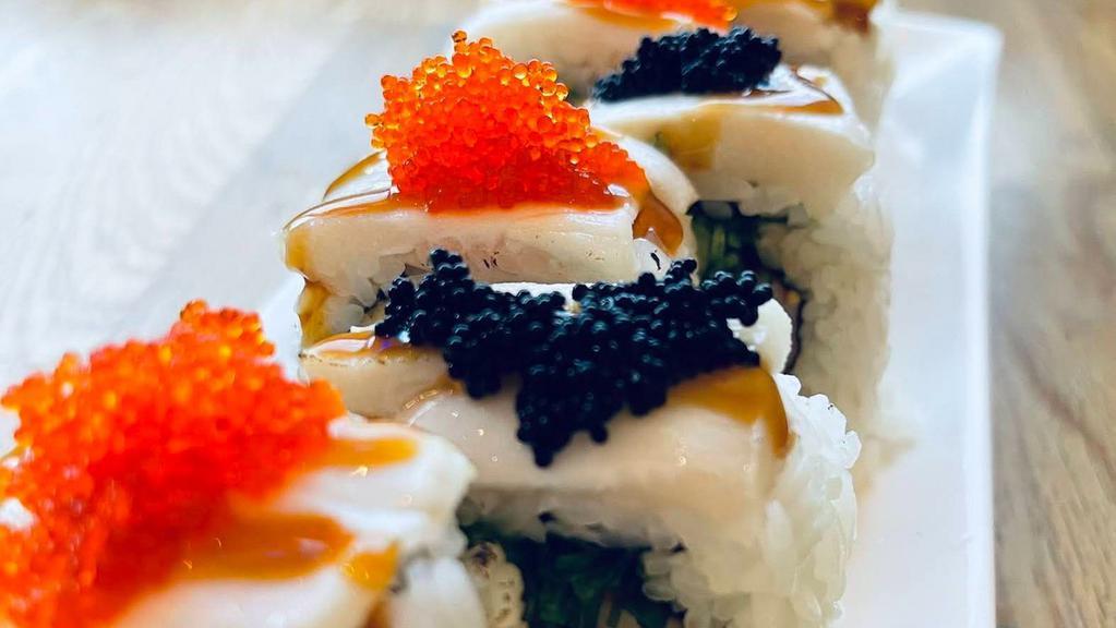 Tiger Roll (Inside Out) · Spicy yellowtail, crab stick, seaweed salad, cucumber, avocado, topped with torched white Tuna, orange and black tobiko, teriyaki.