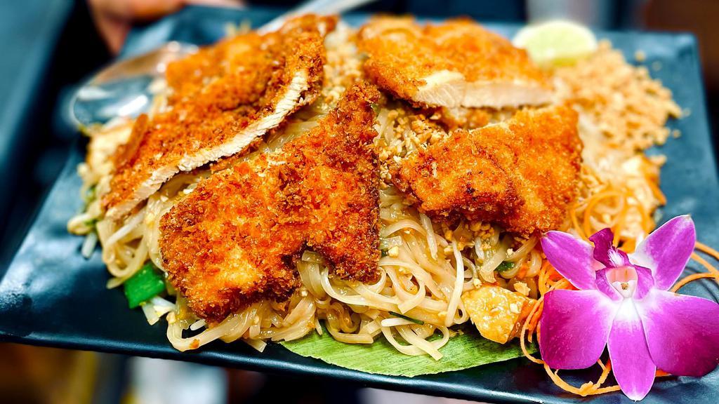 Crispy Chicken Pad Thai · Flat rice noodles, tofu, egg, bean sprouts,chopped salted radish, ground peanuts, scallions topped with fried crispy chicken.