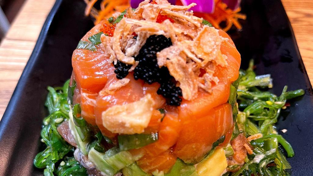 Tuna And Salmon Tartare · Diced fresh Tuna and Salmon in ginger soy lemon dressing, avocado, scallions, served with seaweed salad, cucumbers, tobiko.