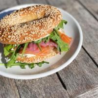 Gravlox Bagel · Bagel with house cured gravlox, cream cheese, pickled red onion, arugula