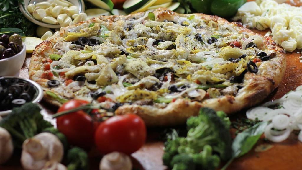 Vegetarian Primavera (White Pizza) · Mozzarella, mushrooms, peppers, onions, black olives, fresh basil, marinated tomatoes and artichoke hearts with our garlic sauce.