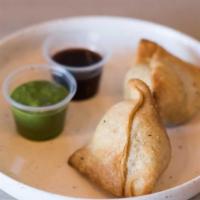 Mini Samosas · two savory puffed pastries stuffed with spiced potatoes and green peas. served with tamarind...
