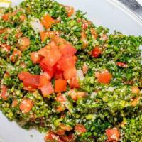 Tabbouleh (Large) · Fresh minced parsley, diced tomatoes, cracked wheat, onions, lemon juice, and olive oil.