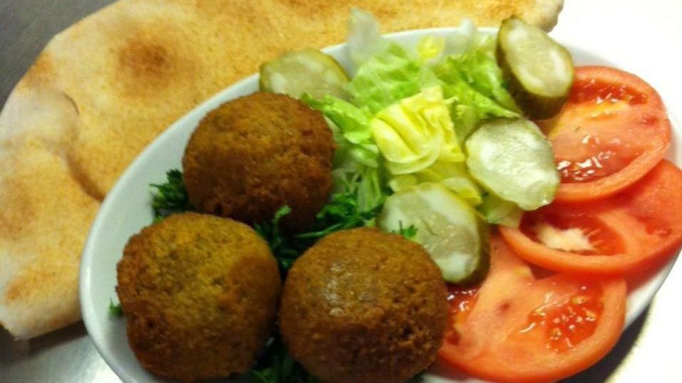 Falafel (Large) · Vegetarian patties made with chickpeas, parsley, tomatoes, and spices. Lightly fried in corn oil and served over a bed of lettuce with tahini sauce.