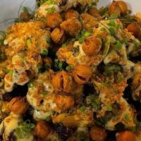 Warm Brussel Caesar · charred brussel sprouts dressed with our creamy vegan caesar, spiced crispy chickpeas, toast...