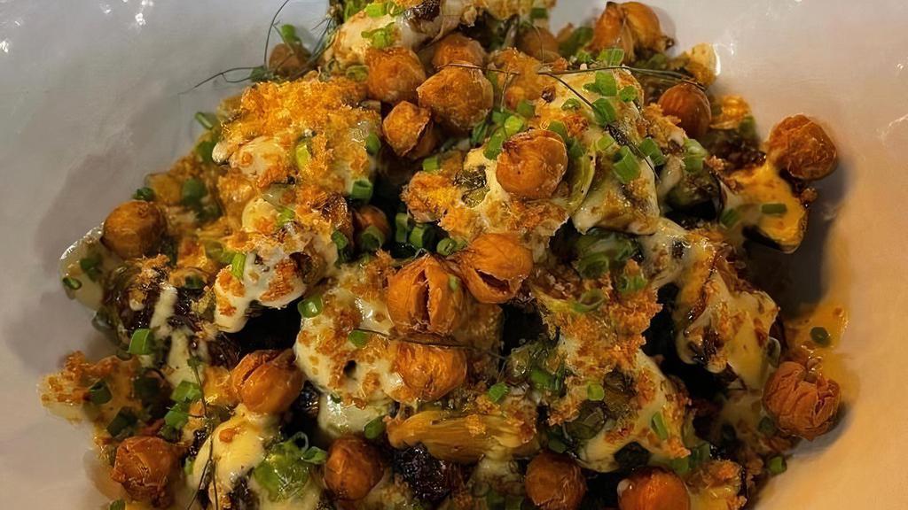 Warm Brussel Caesar · charred brussel sprouts dressed with our creamy vegan caesar, spiced crispy chickpeas, toasted breadcrumbs, and fresh herbs. *plant-based. *caesar dressing contains cashews