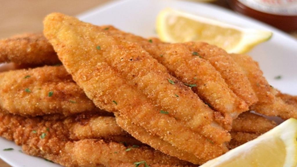 Fried Cajun Catfish · Crispy fried Cajun catfish fillet, served with two side dishes and bread on the side. We fry in premium canola oil.