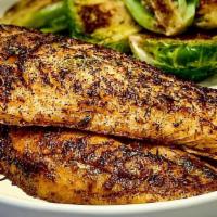 Blackened Grilled Tilapia · Blackened grilled tilapia fillet, served with bread on the side.