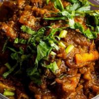 Goat Curry · Curry cooked with onion, tomatoes, ginger, garlic, onion, cumin, tumeric, coriander and chil...