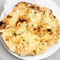 Garlic Naan · Unleavened flour bread stuffed with garlic and topped with fresh cilantro.