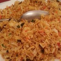 Chicken Biryani · Pieces of chicken and long grain basmati rice cooked in a sealed pot.