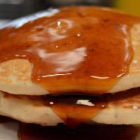Buttermilk Pancakes · Three fluffy hot cakes
