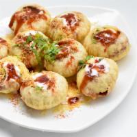 Dahi Puri · Semolina puffs filled with spiced chickpeas, potatoes and mint chutney soup.