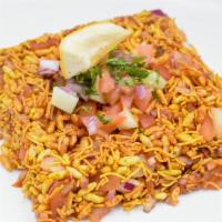 Bhel Puri · Puffed rice crisp made with chick peas flour and mix with onions, tomatoes, spices and tamar...