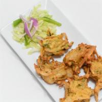 Vegetable Pakora · Fresh vegetable fritters made with spinach, potatoes, onions and cauliflower. Five pieces.