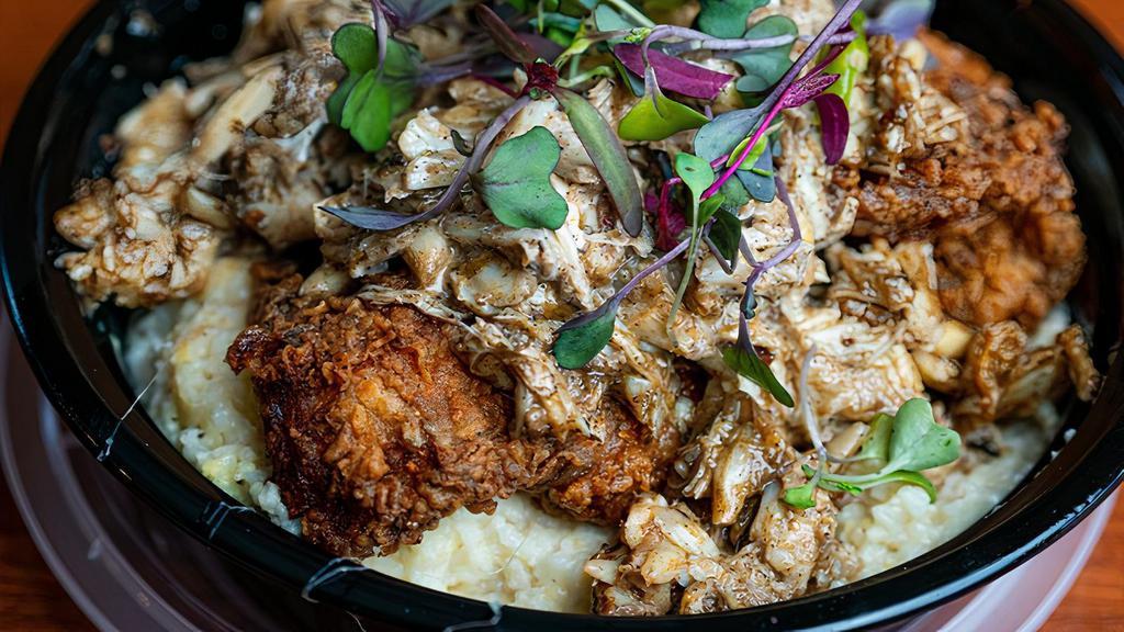 Jerk Catfish & Crab Grits · Deep fried catfish sautéed crab served over white cheddar grits and cream sauce