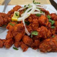 Chicken 65 Masala · Boneless pieces of chicken marinated with Indian spice tossed with onions, tomatoes and spec...