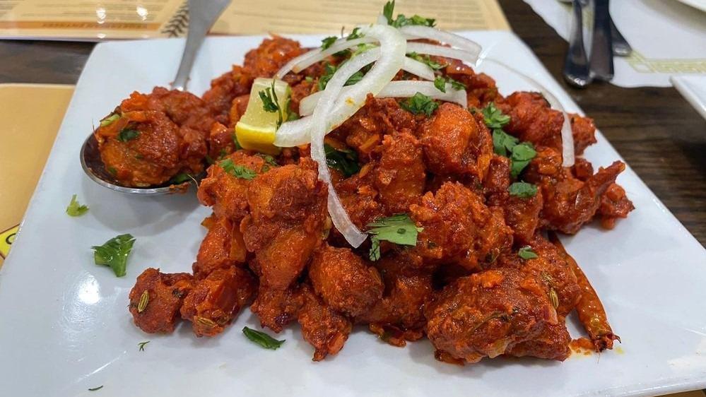 Chicken 65 Masala · Boneless pieces of chicken marinated with Indian spice tossed with onions, tomatoes and special semi dry sauce.