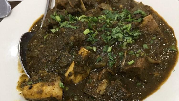 Gongura Mutton Curry · Andhra style spicy goat curry with the distinctive taste of gongura or sorrel leaves.