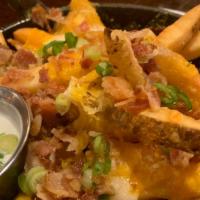 Cheesy Bacon Pub Fries · Nacho cheese and bacon bits, and green onion with ranch on the side, a Village classic. Glut...