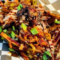 Loaded Pork Fries · Order of our hand cut fries topped with smoked pork shoulder, house cheese sauce, cherry pep...