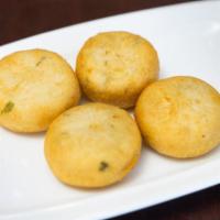 Aloo Tikki · 2 pieces. Potatoes and green pea patties flavored with coriander.
