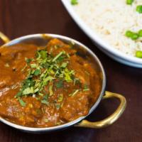 Lamb Rogan Josh · Lamb curry cooked with tomatoes and onions and flavored with cinnamon, cloves and cardamom.
