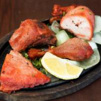 Tandoori Chicken · Kebab of chicken pieces (with bone) marinated in yogurt, ginger, garlic, lemon juice and spi...