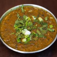 Dal Makhani · A combination of dark lentils simmered overnight in cream and lightly fried in butter.