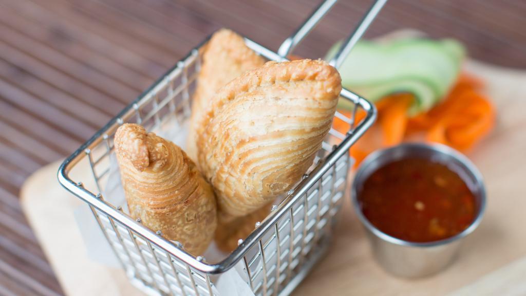 Veggie Curry Puffs · Three pieces. Potato, onion, pea, carrots mixed in curry powder the knot wrapped. Deep fried, served with cucumber sauce.