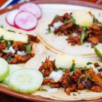 Suadero Taco · Three pieces. Slow cooked beef brisket. Served with onion, cilantro, radish, and cucumber.