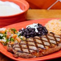 Bistec Coyoacan · Grilled New York strip topped with portabella and melted cheese. Served with rice, black bea...