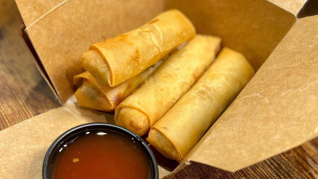Vegetable Spring Rolls · Crisp rolls filled with cabbage, carrots, onions, celery, and glass noodles served with a homemade sweet plum sauce.