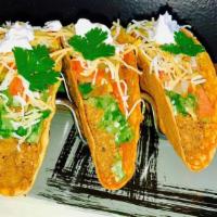 Taco · Crunchy shell filled with ground beef, cheese, pico de gallo, lettuce and sour cream.