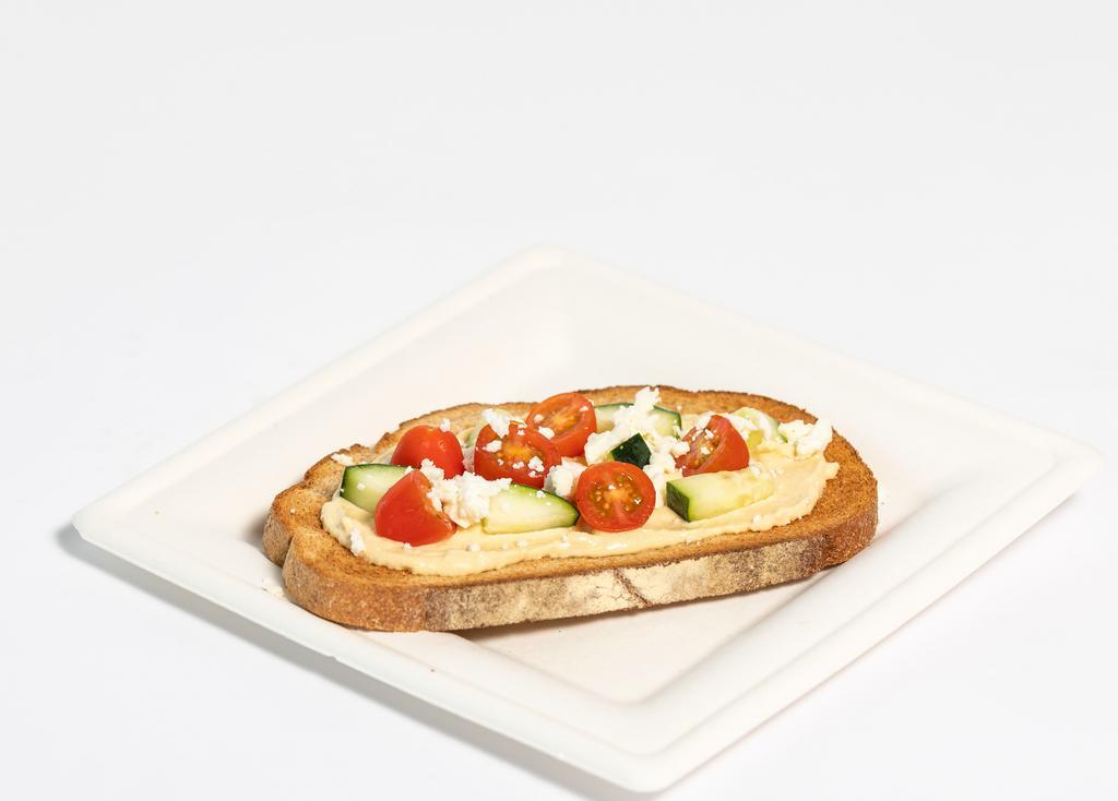 Hummus & Tomato Toast · Organic whole wheat bread, classic hummus, grape tomatoes, diced cucumber, feta cheese, Himalayan salt.