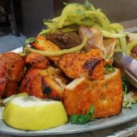 Tandoori Mixed Grill · Chicken, Salmon & Lamb Marinated overnight in Yougrt flavored with indian spices herbs in BBQ