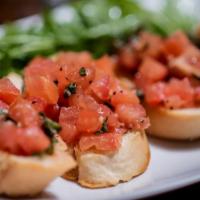 Tomato Bruschetta · Our take on the traditional.  Tomato, Basil & Garlic on a Baguette